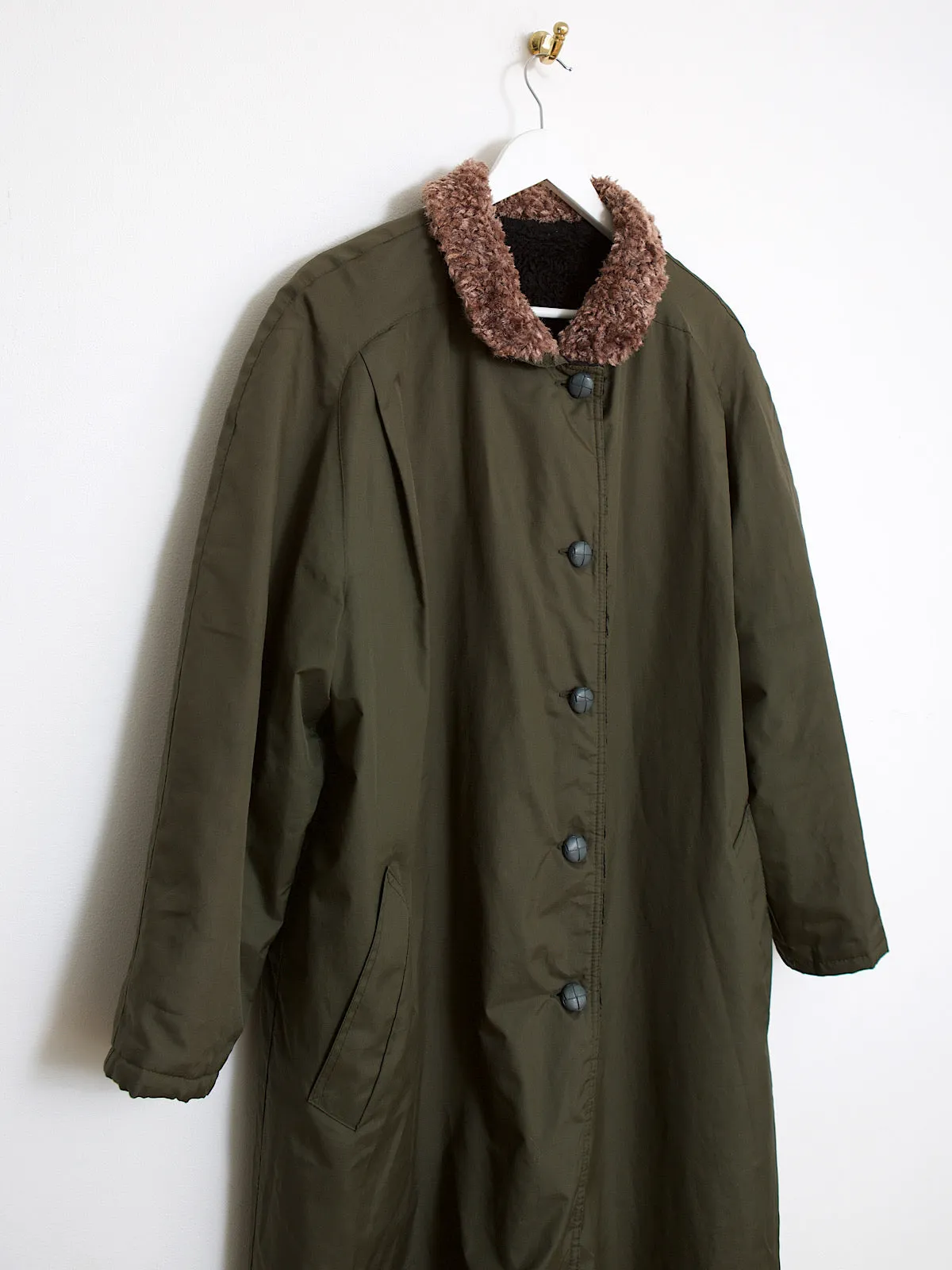 Green waterproof outdoor coat lined with faux fur lining and collar