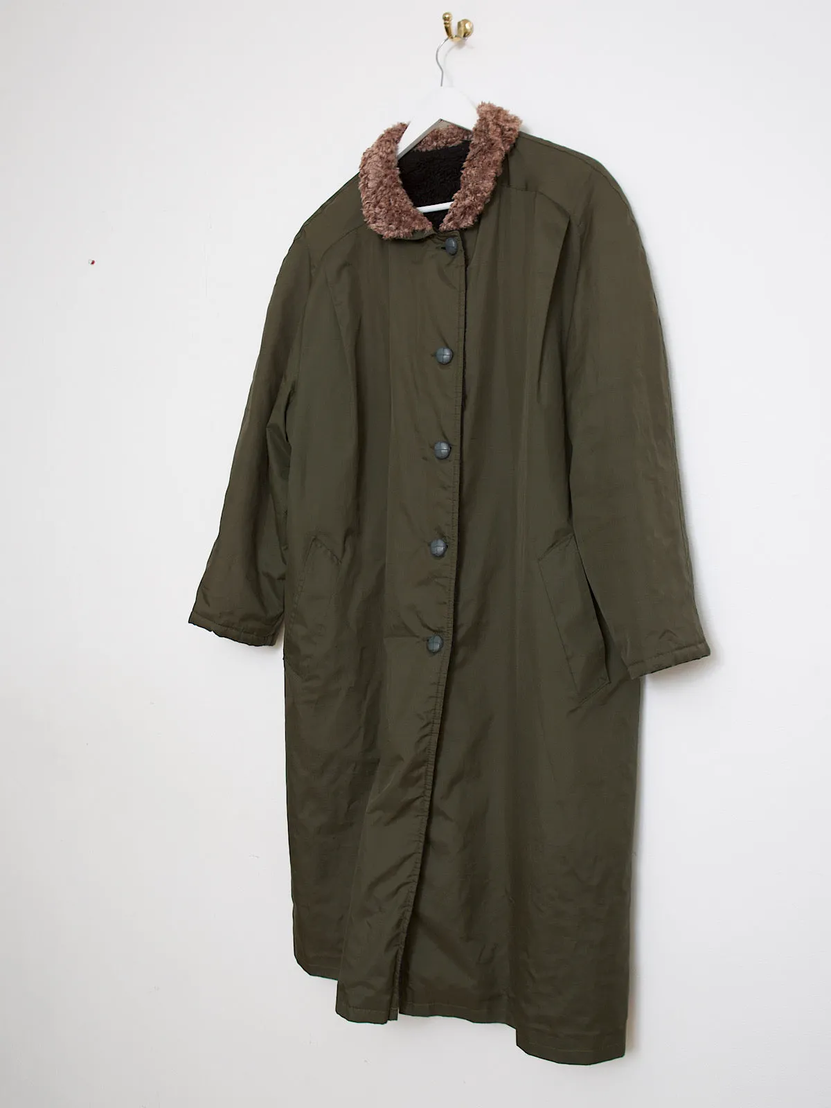 Green waterproof outdoor coat lined with faux fur lining and collar